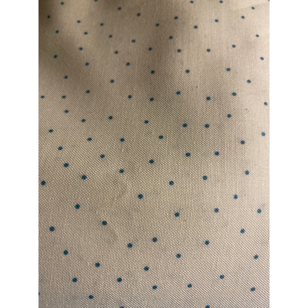 Over 5 contiguous yards of white quilt fabric with tiny blue dots